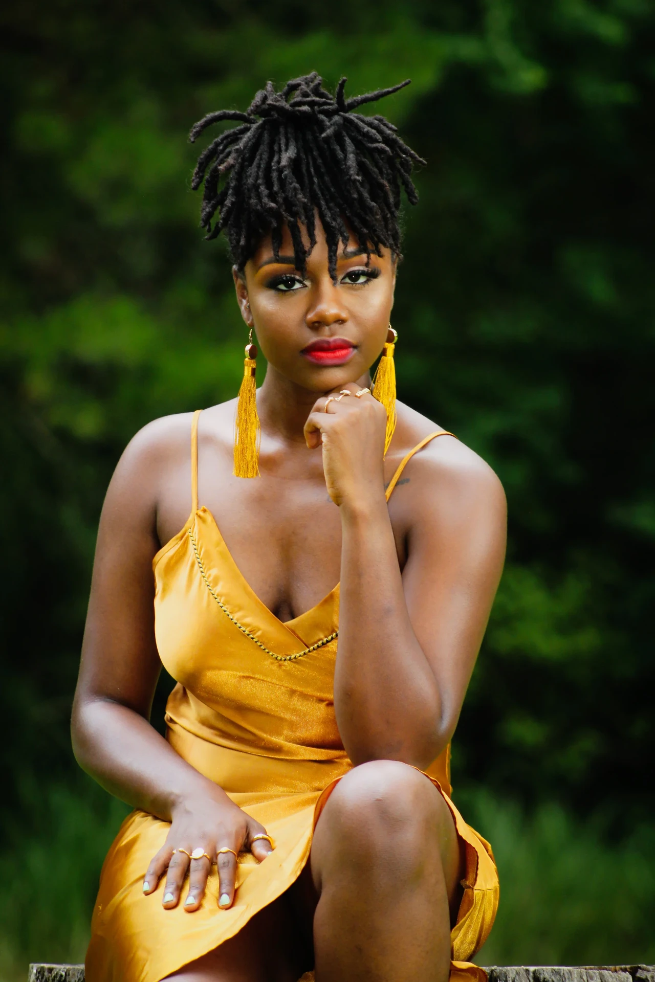 Portrait session photograph in a gold dress outdoors